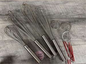 Bundle of metal cooking whisks and strainers