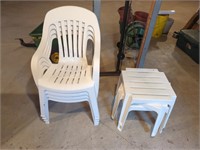 Four plastic lawn chairs with three side tables