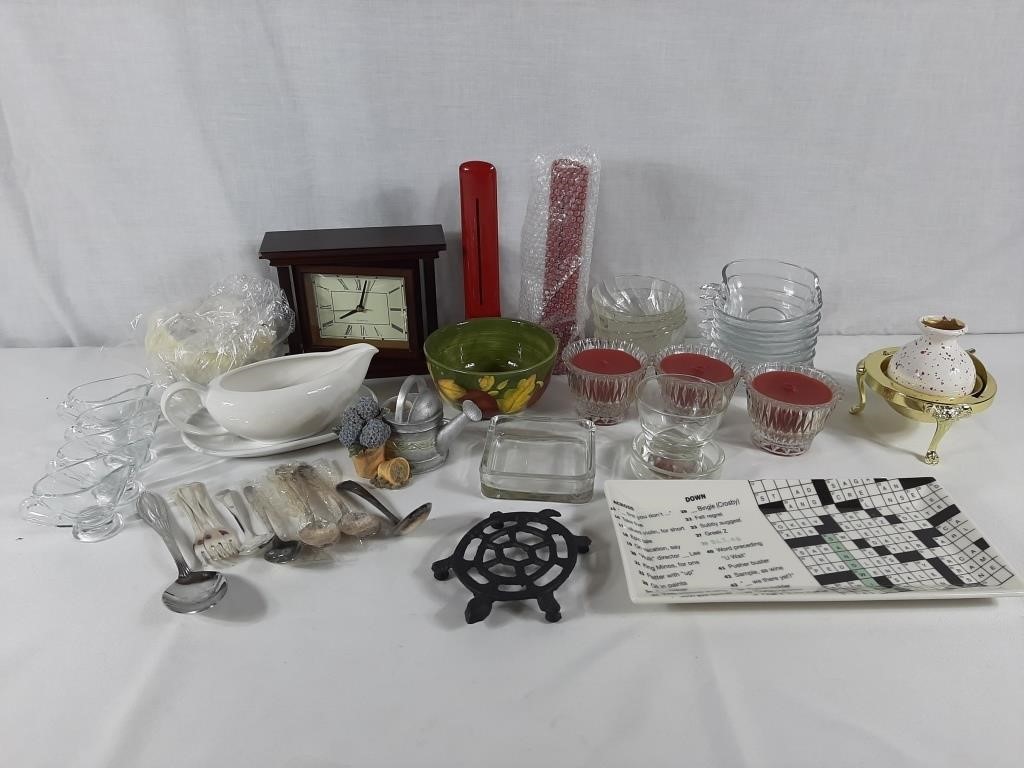 Assorted kitchen supplies with candles and clocks