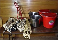 Lot: 4 buckets, saddle rack, nylon leads; as is