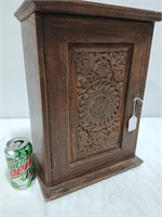Small wooden cabinet w carved door