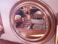 Round wall mirror with thick gold frame,
