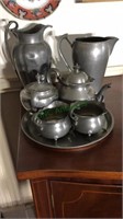 Five piece pewter tea set, two pewter pitchers,