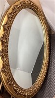 Large oval mirror in wide gold wood ornate frame,