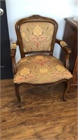 Upholstered sitting chair with carved details in