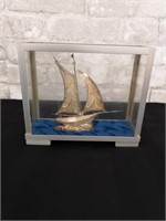 Sloop style replica ship model in glass display.