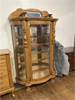 Ornate carved lion curio cabinet