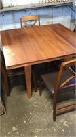 Expanding wooden table with 4 chairs. All 4 s