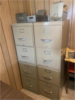 Two file cabinets with contents on top