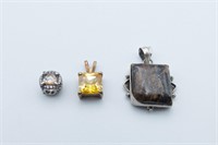 Three sterling silver pendants of graduated sizes