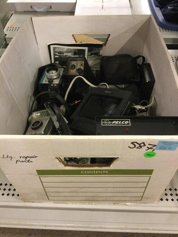 Box of assorted cameras and more. Electronics.