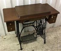 An antique Singer sewing machine built into desk