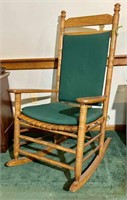 Rocking chair with green cushions and slate seat
