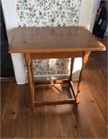 Small side table with a four stretcher base
