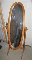 Wood swivel mirror on stand. Measures 59" tall.
