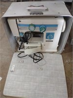 Dressmaker sewing machine in case. One hinge is