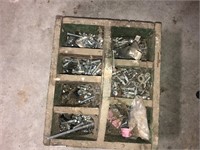 Primitive box full of nuts and bolts