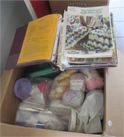 Large box with contents that includes yarn,