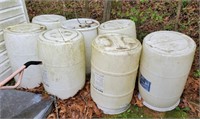 7 white plastic barrels