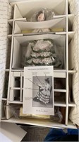Sampler doll in box with stand