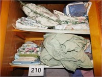 Two top shelves of sheets and pillowcases