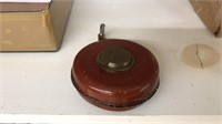 ANTIQUE ENGLISH LEATHER AND BRASS TAPE MEASURE