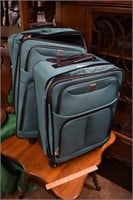 Two Blue Roller Suitcases