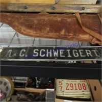 2 tin signs A.C. Schweigert 16"x 3"