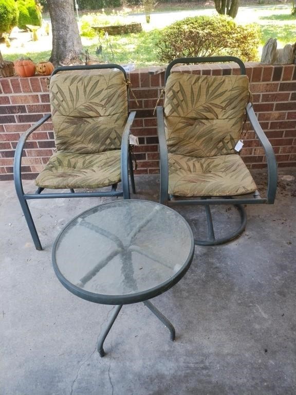 2 metal chairs and a round table