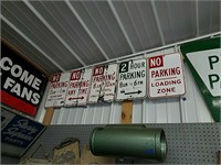 Five no parking signs. No parking 11 a.m. to 1