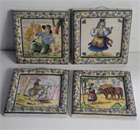 Collection of four handpainted clay wall plaques