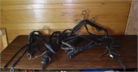 Collection of black leather draft horse harness; a