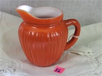 small ribbed orange pitcher/creamer