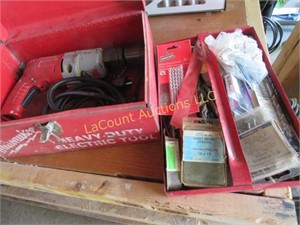 Milwaukee drill and accessories in metal case