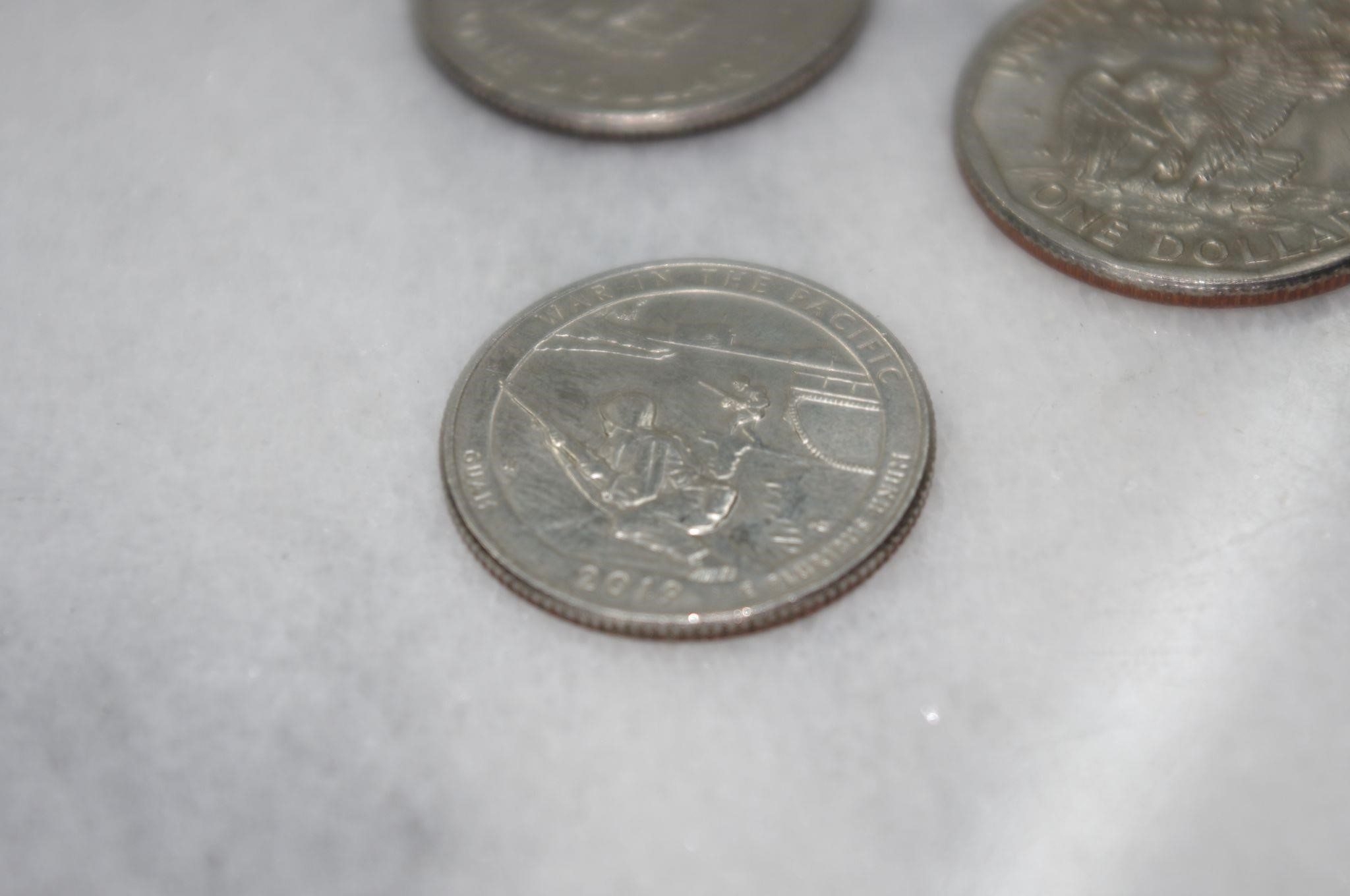 Three Liberty Dollars and Two Rare Quarters