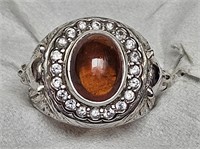 RING MARKED 925 SILVER WITH STONE AND LION HEADS