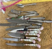 Group of stainless flatware and knives