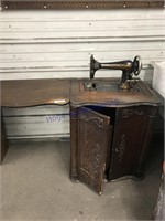 Franklin treadle sewing machine in wood cabinet