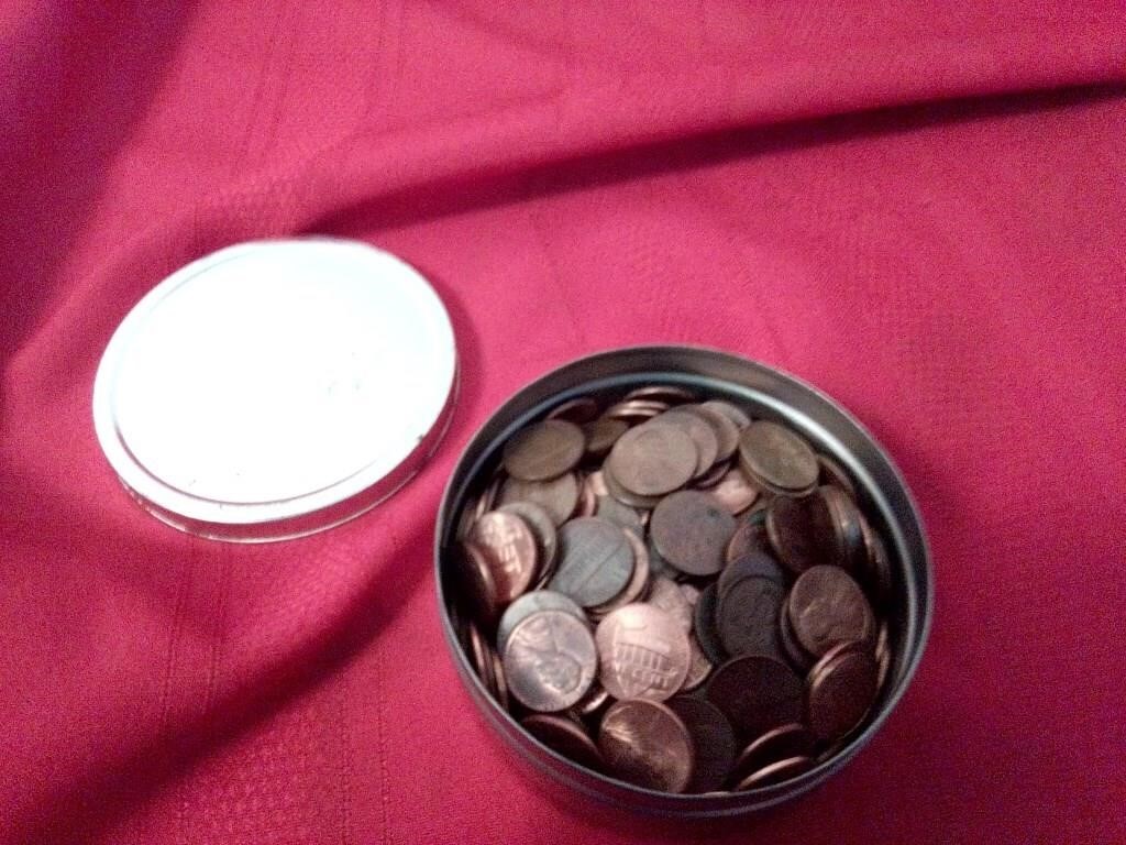 Tin of older pennies