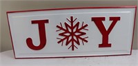 White and red metal 'JOY' sign