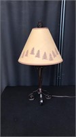 A beautiful table metal lamp with pinecones
