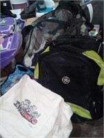 Lot of backpacks, clutch purses, and cloth book