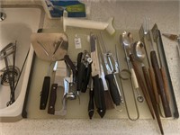 Kitchen utensils on cutting board can opener,