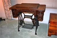 Singer treadle sewing machine in oak cabinet