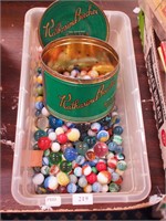 Container of marbles including shooters