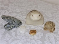 five carved stone frogs