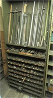 Rack with contents that includes drill bits,