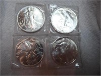 Four 1990 silver dollars