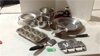 Metal mixing bowls, gravy boat, baking tins and