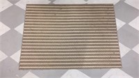 Brown a beige rug with zigzag pattern